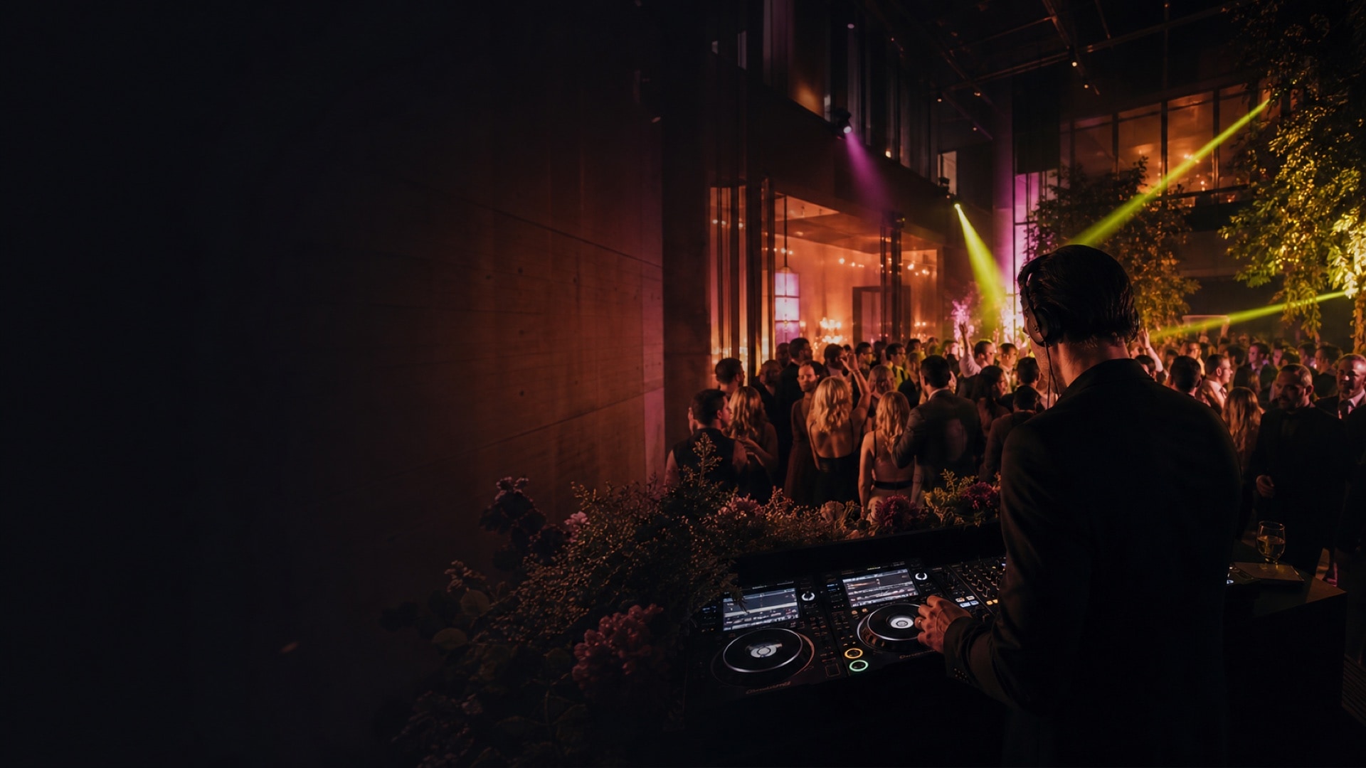 DJ spelar för ett dansgolv fullt av gäster